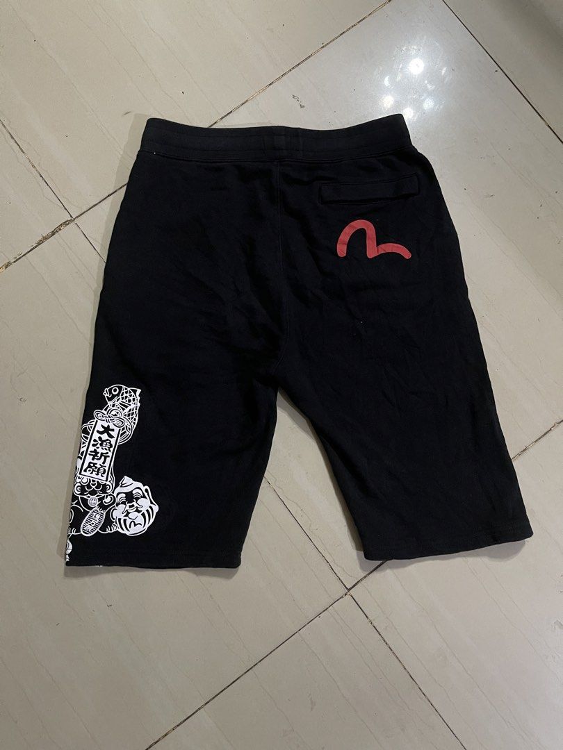 Evisu Heritage Custom Made Black Graphic Shorts Size M (Category: Shorts) located in Manila. Submitted by stuzzygod (Listing ID 1469084779, Image 2). Description: - Brand: Evisu Heritage (Custom Made) - Size 28 - Length 23 - Color: Black - Size: M (fits waist 28 to 33) - Material: Soft fleece cotton - Features: Drawstring waistband, front pockets, single back pocket - Details: Graphic prints on left leg and Japanese typography - Condition: Very c