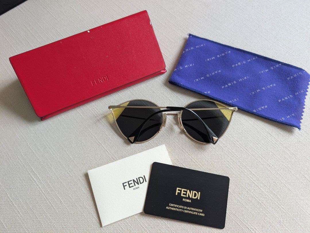 Fendi FF Gold Metal Cateye (Category: Sunglasses & Eyewear) located in Pasig City. Submitted by ejereyes (Listing ID 1468974885, Image 3). Description: Fendi FF 0341/S Gold Metal Cateye Guaranteed authentic Complete set with red Fendi leather triangular case, authentication card, envelope, and blue Paris Miki cleaning cloth Honest issue: Case material has some peeling. But this doesn't affect the condition of the sunglasses. RFS: Downsizing perso