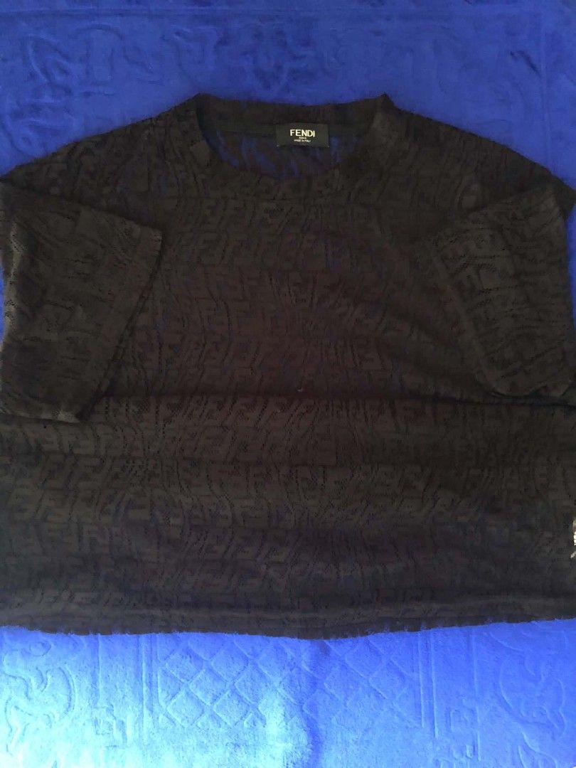 Fendi FF Monogram Lace Black T-Shirt (Category: Shirts) located in Manila. Submitted by wonderboi80 (Listing ID 1468981188, Image 1). Description: Fendi black t-shirt made from lace fabric. All-over FF monogram pattern throughout the body and sleeves. Classic crew neck design. Interior brand label stitched near the collar. Care label shows size information and material composition clearly. Made in Italy construction..
