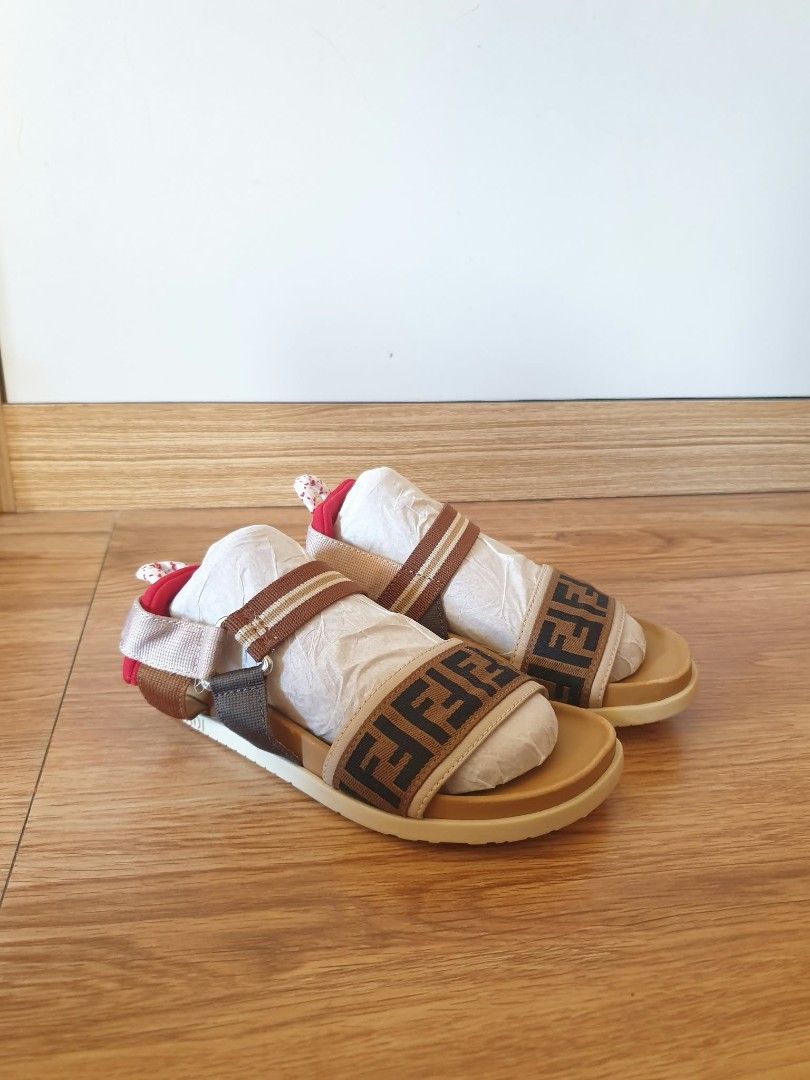 Fendi Kids Sandals (Category: Babies & Kids Fashion) located in Laoag. Submitted by alyssamarie_2918 (Listing ID 1468982462, Image 1). Description: - Brand: Fendi Kids - Design: Iconic brown and black FF logo pattern with a vibrant red heel accent - Size: 30 (Marked on sole) - Origin: Made in Italy - Condition: Brand new, never worn outside, clean soles, still includes original paper stuffing from storage - Features: Adjustable strap for a secure