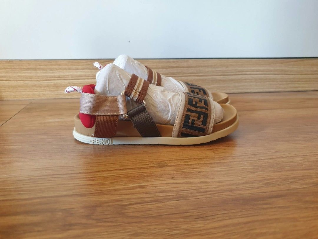 Fendi Kids Sandals (Category: Babies & Kids Fashion) located in Laoag. Submitted by alyssamarie_2918 (Listing ID 1468982462, Image 3). Description: - Brand: Fendi Kids - Design: Iconic brown and black FF logo pattern with a vibrant red heel accent - Size: 30 (Marked on sole) - Origin: Made in Italy - Condition: Brand new, never worn outside, clean soles, still includes original paper stuffing from storage - Features: Adjustable strap for a secure