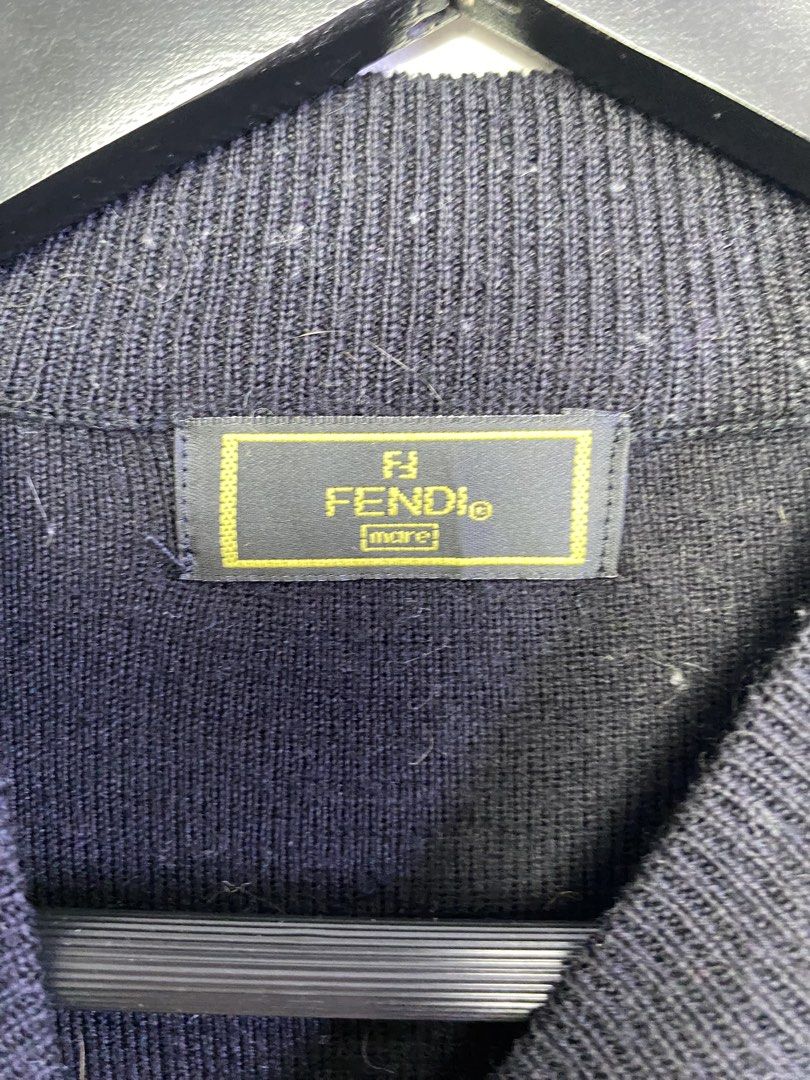 Fendi Mare FF Logo Wool Blend Sweater (Category: Luxury Apparel) located in Manila. Submitted by declutterpromax (Listing ID 1468976408, Image 2). Description: - Brand: Fendi Mare - Material: 80% Wool, 20% Acrylic (Warm and comfortable knitwear) - Color: Black and Grey with solid black sleeves - Design: Classic FF logo monogram pattern on the front panel with a ribbed mock neck - Origin: Made in Italy - Condition: Great for cooler weather and eve