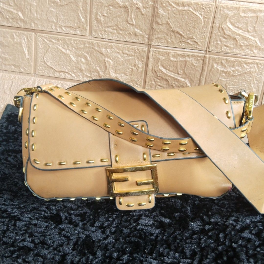Fendi Tan Leather Studded Shoulder Bag (Category: Luxury Bags & Wallets) located in Lubao. Submitted by dione_closet503 (Listing ID 1469047435, Image 1). Description: - Authentic Fendi tan leather shoulder bag - Iconic gold-tone hardware and signature FF front clasp - Stylish studded strap and edge trim details - Adjustable shoulder strap for a custom fit - Spacious interior compartment under the front flap - Classic structured shape with chic co