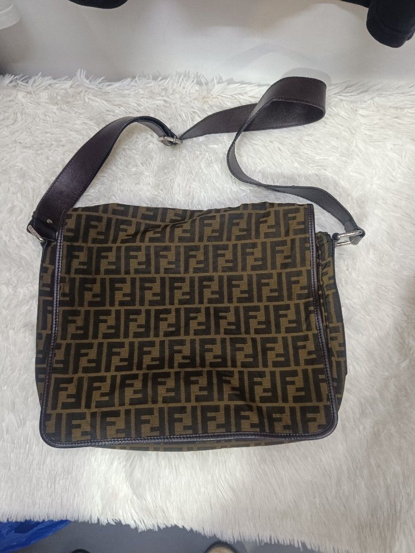 Fendi Zucca Print Messenger Bag (Category: Luxury Bags & Wallets) located in Pateros City. Submitted by harry062182 (Listing ID 1469086527, Image 1). Description: - Authentic Fendi Zucca canvas messenger bag in brown and black - Adjustable dark brown leather strap for a custom fit - Sleek silver-tone hardware and classic flap with magnetic snap closure - Made in Italy (interior tag intact) - Spacious interior with clean fabric, perfect for daily 