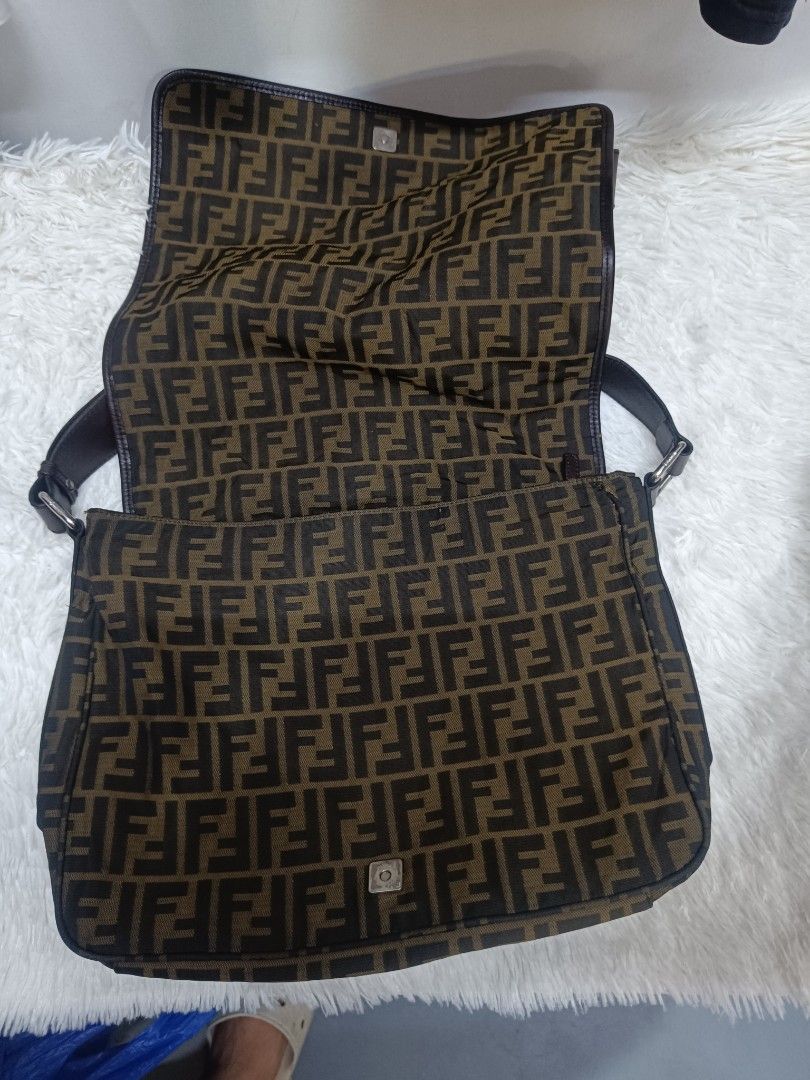 Fendi Zucca Print Messenger Bag (Category: Luxury Bags & Wallets) located in Pateros City. Submitted by harry062182 (Listing ID 1469086527, Image 3). Description: - Authentic Fendi Zucca canvas messenger bag in brown and black - Adjustable dark brown leather strap for a custom fit - Sleek silver-tone hardware and classic flap with magnetic snap closure - Made in Italy (interior tag intact) - Spacious interior with clean fabric, perfect for daily 