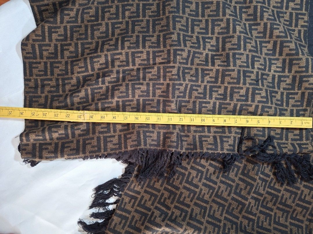 Fendi Zucchino FF Logo Pattern Scarf Black Brown (Category: Scarves) located in Baguio. Submitted by restyrille77846 (Listing ID 1469063304, Image 2). Description: - Authentic Fendi reversible scarf - Features iconic brown and black FF Zucchino monogram pattern - Reverse side is solid black for versatile styling - Styled with classic fringe details on both ends - Soft and cozy woven fabric, ideal for cooler weather - Measures approximately 27 to 