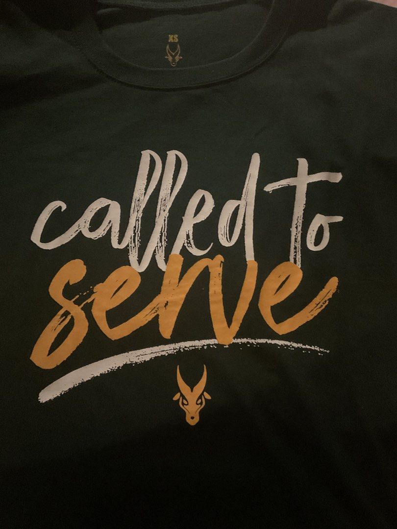FEU NSTP SHIRT (Category: Shirts) located in Quezon City. Submitted by analiza_venigas1247 (Listing ID 1469036115, Image 1). Description: - Color: Dark green - Design: 'Called to Serve' graphic print with antelope logo - Size: XS (printed inside collar) - Fit/Style: Crew neck, short sleeves .