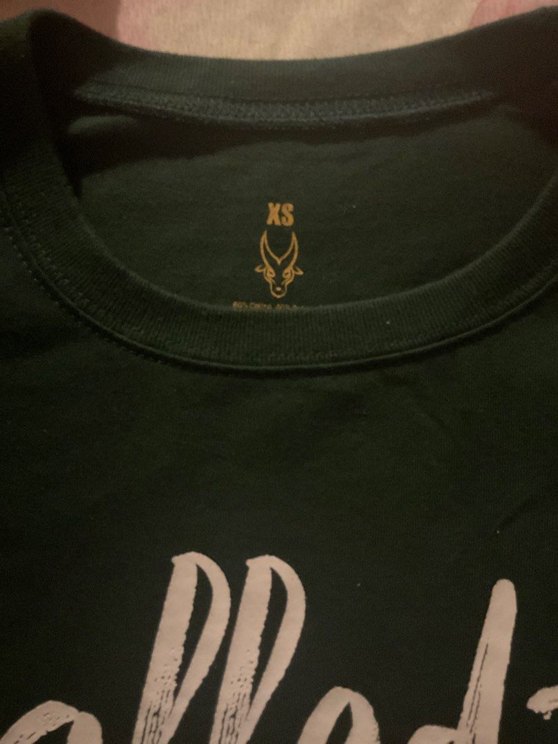FEU NSTP SHIRT (Category: Shirts) located in Quezon City. Submitted by analiza_venigas1247 (Listing ID 1469036115, Image 2). Description: - Color: Dark green - Design: 'Called to Serve' graphic print with antelope logo - Size: XS (printed inside collar) - Fit/Style: Crew neck, short sleeves .
