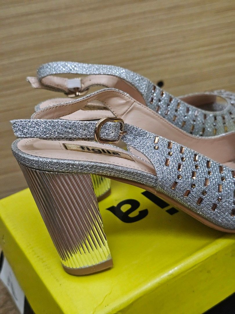 Figlia Silver Glitter Peep Toe Slingback Heels Size 36 (Category: Heels) located in Marikina City. Submitted by czarinahwithh (Listing ID 1469064255, Image 3). Description: - Brand: Figlia - Style: Glitter slingback heels with open toe - Color: Silver with chunky ribbed metallic heels - Details: Beautiful crystal and bead embellishments on the front, 3 inches heels - Fit: Size 36 (stamped inside) - Closure: Adjustable slingback strap with a gold 