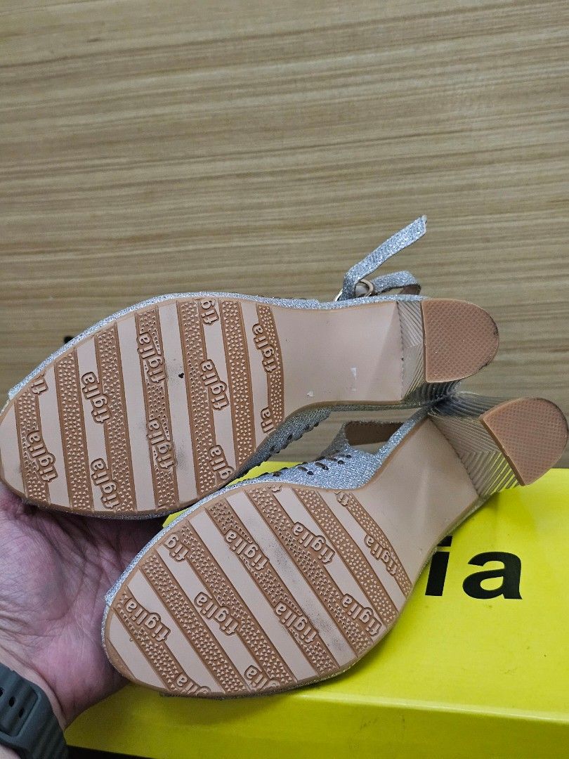Figlia Silver Glitter Peep Toe Slingback Heels Size 36 (Category: Heels) located in Marikina City. Submitted by czarinahwithh (Listing ID 1469064255, Image 2). Description: - Brand: Figlia - Style: Glitter slingback heels with open toe - Color: Silver with chunky ribbed metallic heels - Details: Beautiful crystal and bead embellishments on the front, 3 inches heels - Fit: Size 36 (stamped inside) - Closure: Adjustable slingback strap with a gold 