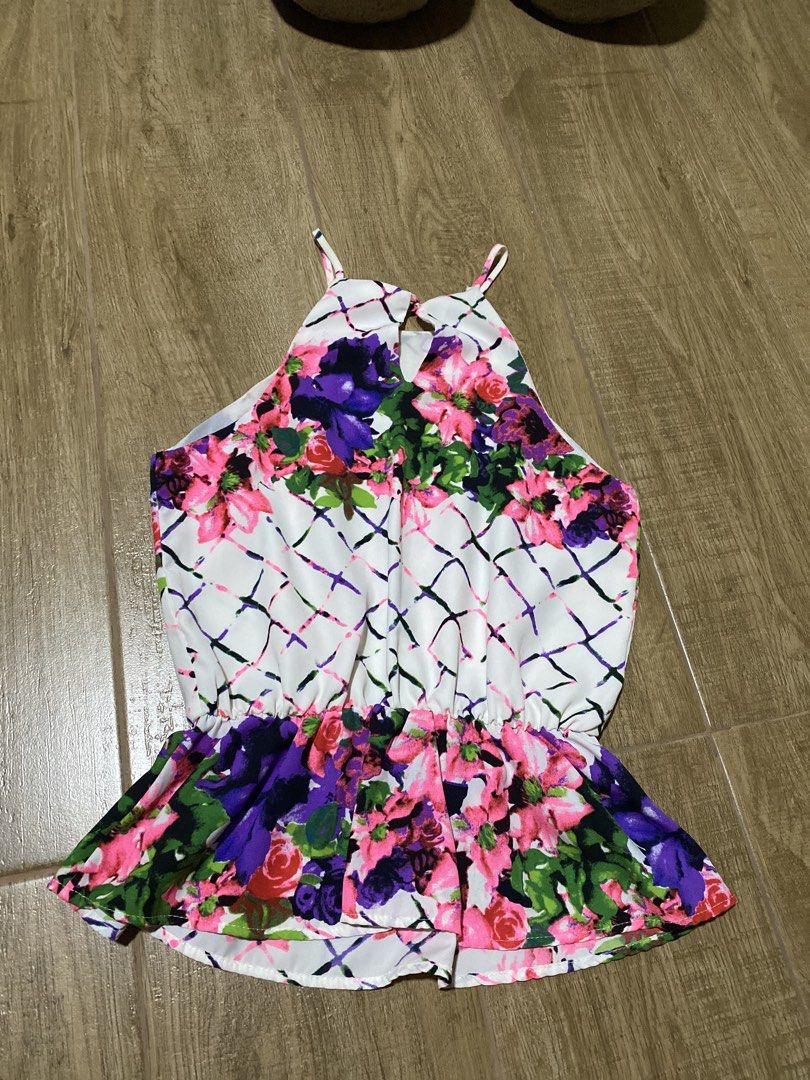 Floral Halter Neck Peplum Blouse (Category: Sleeveless) located in Imus. Submitted by sushicat.ph (Listing ID 1469009247, Image 2). Description: - Vibrant floral print on white background with purple, pink, and green flowers - Chic halter neck design with thin straps and back keyhole button closure - Gathered elastic waist with a flouncy, flattering peplum hem - Lightweight fabric featuring a subtle abstract lattice pattern - Ideal for warm weath