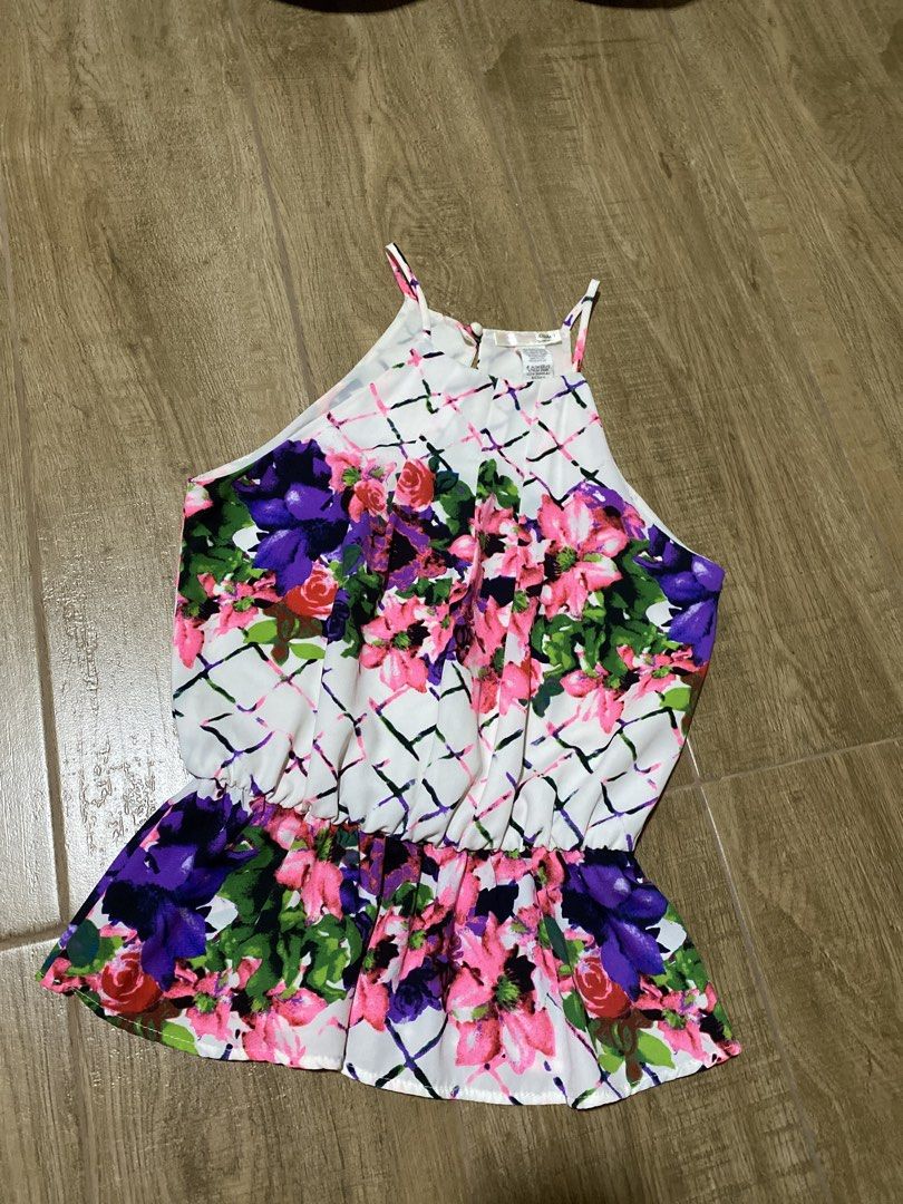 Floral Halter Neck Peplum Blouse (Category: Sleeveless) located in Imus. Submitted by sushicat.ph (Listing ID 1469009247, Image 1). Description: - Vibrant floral print on white background with purple, pink, and green flowers - Chic halter neck design with thin straps and back keyhole button closure - Gathered elastic waist with a flouncy, flattering peplum hem - Lightweight fabric featuring a subtle abstract lattice pattern - Ideal for warm weath