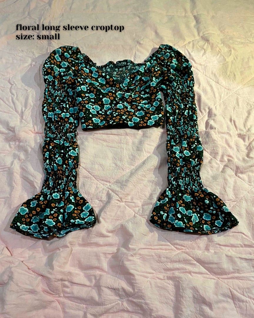 Floral long sleeve croptop (Category: Longsleeves) located in Santa Cruz. Submitted by gelpcz (Listing ID 1468950593, Image 1). Description: - Size: Small - Style: Floral long sleeve crop top with a trendy, cute vibe - Print: Dark background with all-over blue and orange flowers - Details: Smocked bodice and chic square neckline - Sleeves: Dramatic flared bell sleeves with smunching along the arms - Condition: Great addition to your wardrobe!.