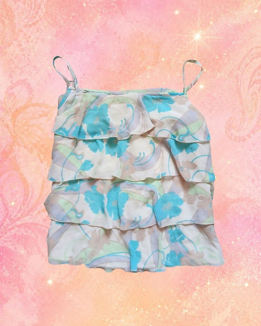 Floral Ruffle Camisole Tank Top (Category: Sleeveless) located in Antipolo. Submitted by mochisky (Listing ID 1468972847, Image 1). Description: - Multi-layered ruffle tank top with a charming light blue floral print - Features adjustable-look spaghetti straps and a breezy, lightweight fabric - Lovely pastel mix of blue, green, and beige tones - Versatile and stylish addition to your summer wardrobe - Condition: Brand new / Excellent (ready to we