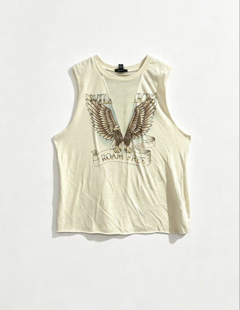 FOREVER 21 (Category: Sleeveless) located in Davao. Submitted by sart0ria85 (Listing ID 1468982111, Image 1). Description: A cream Wild Hearts Roam Free' eagle graphic print. Mesh V-insert panel at the neckline. 60%COTTON 40%POLYESTER MADE IN CHINA 🇨🇳 MEDIUM. Size 6 EXCELLENT CONDITION (94/100).