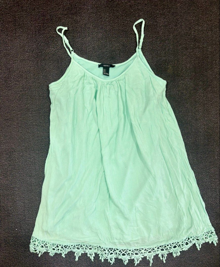 Forever 21 Mint Green Cami Top Size S (Category: Sleeveless) located in Quezon City. Submitted by fast.closetfinds (Listing ID 1469021535, Image 2). Description: - Brand: Forever 21 - Size: S - Color: Mint Green - Details: Adjustable spaghetti straps, cute crochet lace trim on the bottom hem - Fabric: Lightweight and textured, perfect for hot weather - Condition: Good, with a small snag near the front middle section (priced accordingly).
