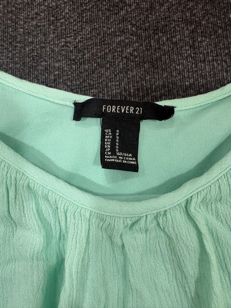 Forever 21 Mint Green Cami Top Size S (Category: Sleeveless) located in Quezon City. Submitted by fast.closetfinds (Listing ID 1469021535, Image 3). Description: - Brand: Forever 21 - Size: S - Color: Mint Green - Details: Adjustable spaghetti straps, cute crochet lace trim on the bottom hem - Fabric: Lightweight and textured, perfect for hot weather - Condition: Good, with a small snag near the front middle section (priced accordingly).