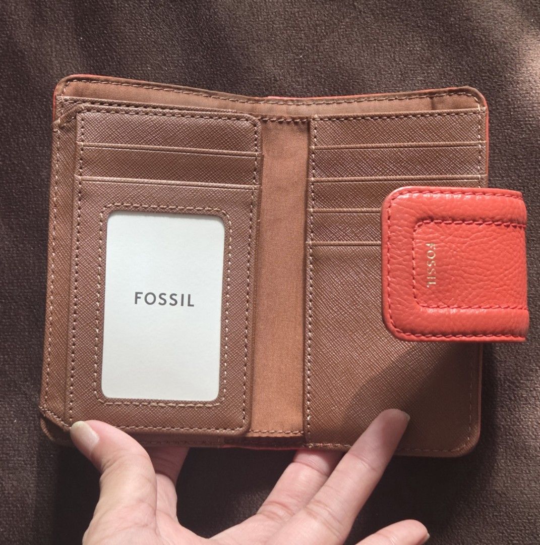 Fossil Bright Red and Brown Leather Wallet (Category: Wallets & Card holders) located in Quezon City. Submitted by belladiva (Listing ID 1468943476, Image 2). Description: - Brand: Fossil - Color: bright and brown - Closure: Secure front snap tab with gold foil logo - Interior: Multiple card slots, clear ID window, and brown textured lining - Design: Compact bifold size that fits easily into small handbags - Condition: Excellent, clean stitching 