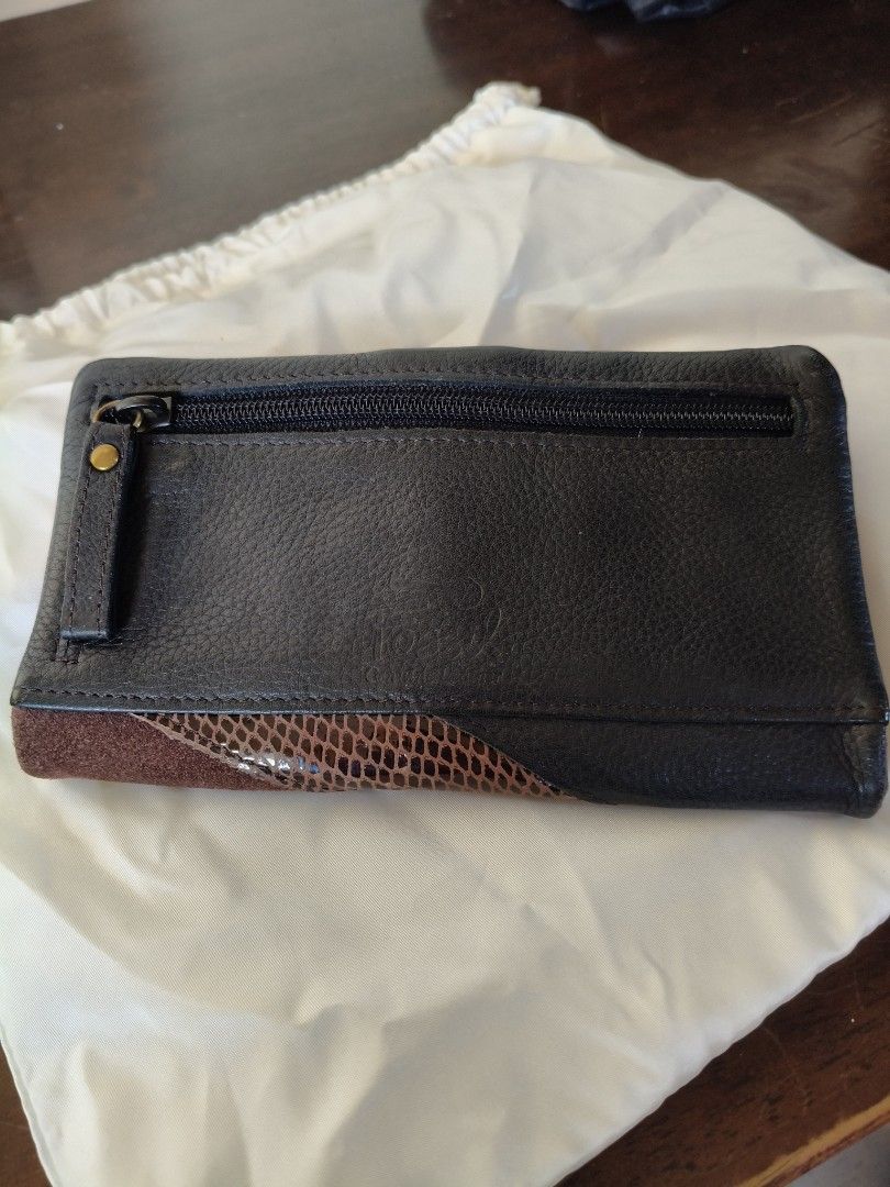 Fossil Multi-texture Patchwork Leather Wallet with Zipper Pocket (Category: Wallets & Card holders) located in Santa Rosa. Submitted by iammarien2nette (Listing ID 1469015398, Image 2). Description: - Authentic Fossil leather wallet - Stylish mix of black, brown, and snakeskin exterior textures - Secure snap button closure - Features multiple card slots and an ID window - Convenient back exterior zippered coin pouch - Beautiful patterned interior