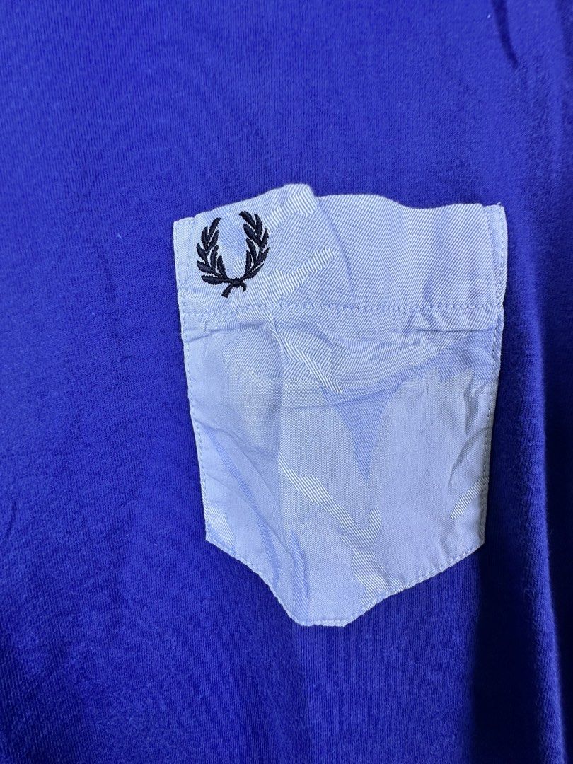 Fred Perry Blue Pocket T-Shirt Size M (Category: Tshirts & Polo Shirts ) located in Manila. Submitted by declutterpromax (Listing ID 1468969951, Image 2). Description: - Brand: Fred Perry - Color: Blue with contrasting light blue pocket - Size: M - Model: M8368 - Features: Embroidered laurel wreath logo on chest pocket, crew neck, short sleeves - Origin: Made in China - Condition: Clean fabric, standard casual fit - Perfect for daily casual styli