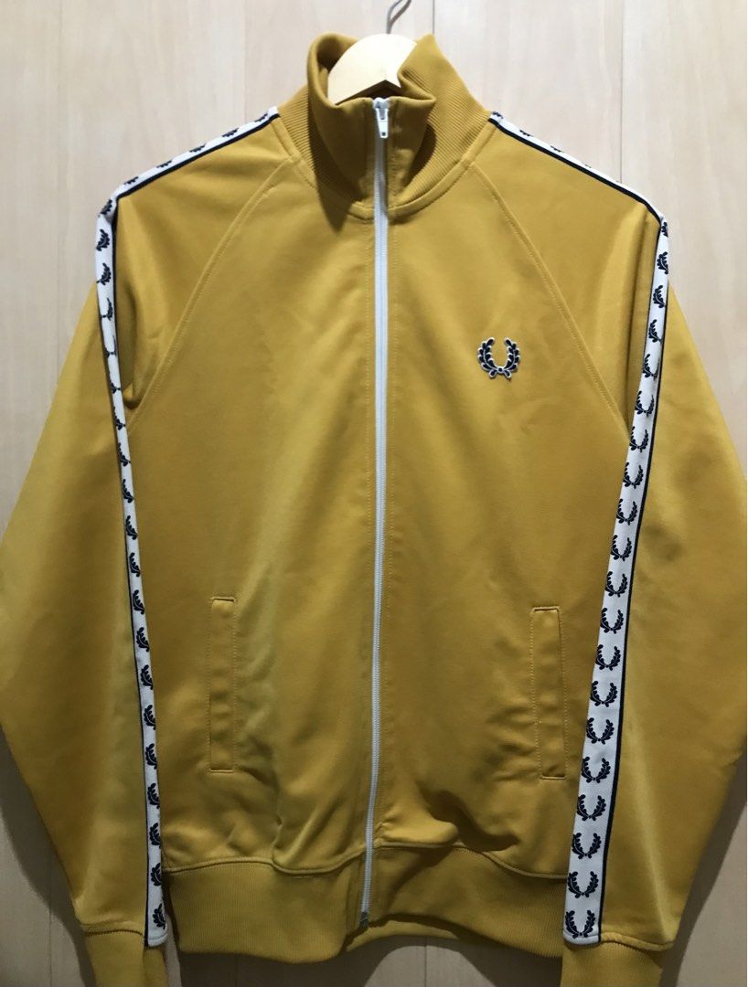 Fred Perry Laurel Taped Track Jacket AUTHENTIC (Category: Coats, Jackets and Outerwear) located in Davao. Submitted by tripgapprl (Listing ID 1469106182, Image 3). Description: Preloved not thrifted Fred Perry track jacket authentic, bought on Japan early 2010. Color: Mustard Dimes: 19.5 width - 26 length Best fit: Mens(Small) Womens(Medium) Size on tag: Xs Condition: 9.6/10 Color rate: 9.5/10 YKK zipper Need wash hem parts Issue: minor white sta