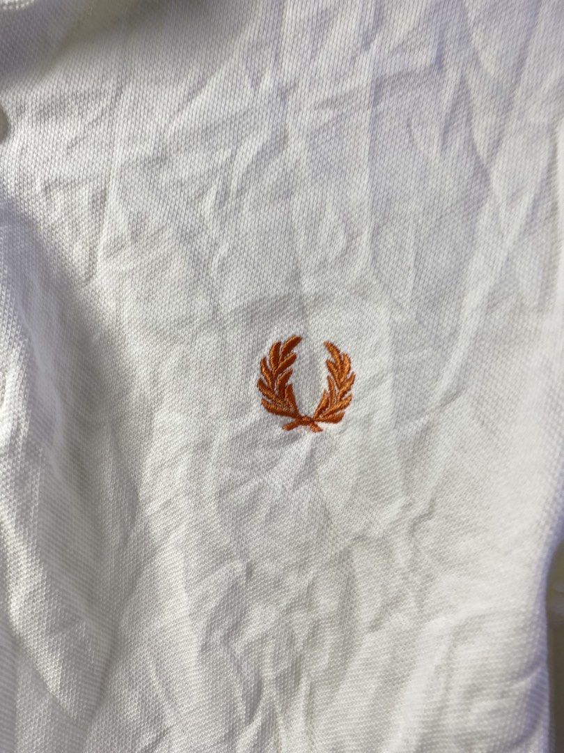 Fred Perry Polo Shirt White Size S M1618 (Category: Tshirts & Polo Shirts ) located in Manila. Submitted by declutterpromax (Listing ID 1468997472, Image 2). Description: - Brand: Fred Perry (Model M1618) - Color: Crisp White with Navy & Orange twin tipping - Size: Small (Regular Fit) - Material: Premium Cotton Piqué - Details: Embroidered orange laurel wreath logo, two-button placket - Origin: Made in China with standard care label - Condition: 