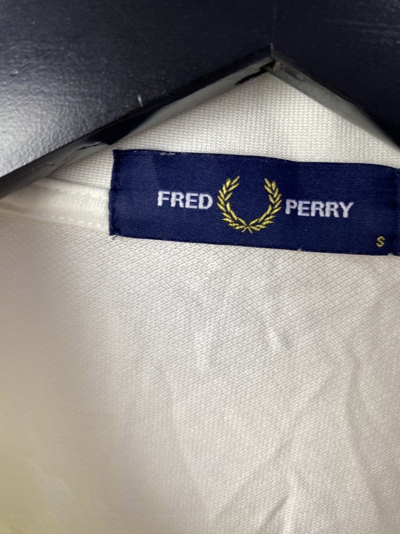Fred Perry Polo Shirt White Size S M1618 (Category: Tshirts & Polo Shirts ) located in Manila. Submitted by declutterpromax (Listing ID 1468997472, Image 3). Description: - Brand: Fred Perry (Model M1618) - Color: Crisp White with Navy & Orange twin tipping - Size: Small (Regular Fit) - Material: Premium Cotton Piqué - Details: Embroidered orange laurel wreath logo, two-button placket - Origin: Made in China with standard care label - Condition: 