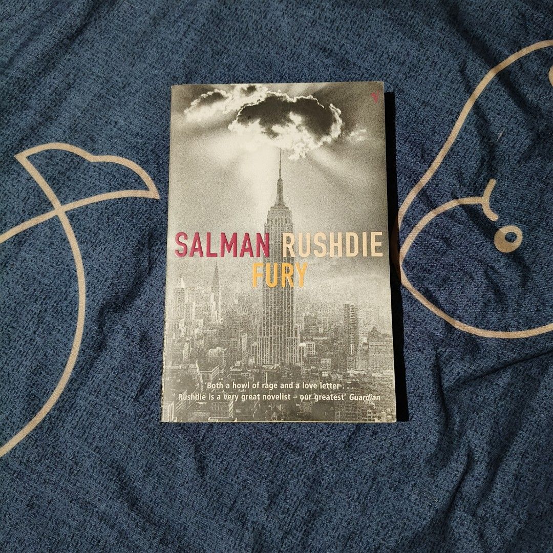 Fury by Salman Rushdie (Category: Storybooks) located in Santo Domingo. Submitted by rajjinni (Listing ID 1469060416, Image 1). Description: - Title & Author: Fury by Salman Rushdie - Format: Paperback with Empire State Building cover graphic - Condition: Read once, stored on bookshelf, clean spine with clear titles, and minor age-related yellowing - Genre: Great read for contemporary fiction fans.