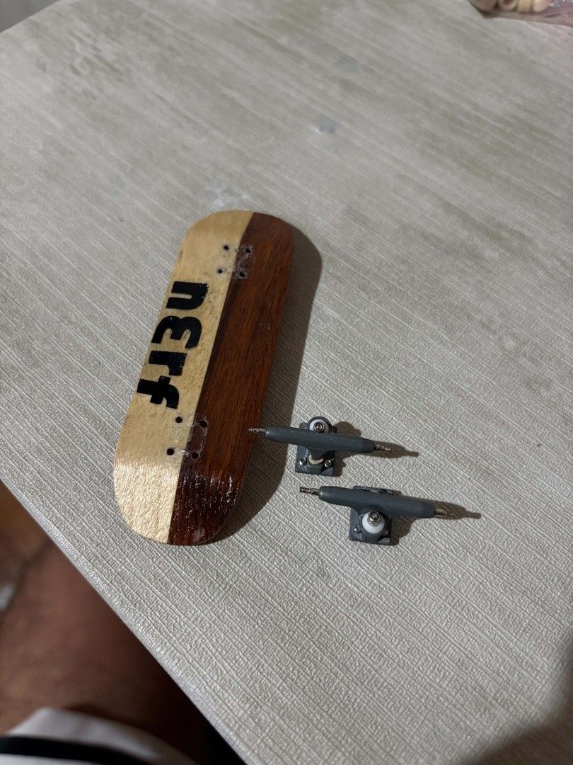 Fyre deck reshape to 29mm bravo trucks 32mm (Category: Skates, Rollerblades & Scooters) located in Manila. Submitted by deelerr (Listing ID 1469131908, Image 2). Description: - Brand: Fyre Fingerboards - Design: Vibrant orange with a flame logo and custom black lettering on natural wood grain - Hardware: Includes two grey trucks with white bushings - Assembly: Pre-drilled screw holes, ready to set up - Condition: Brand new and perfect for all fin