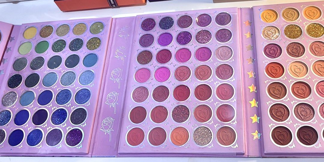 G21 Dear January Version 2.0 Eyeshadow Palette (Category: Makeup) located in Bacoor. Submitted by micsr (Listing ID 1469129039, Image 3). Description: - Brand: G21 Brand (Dear January Version 2.0) - Packaging: Large book-style with portrait cover (purple theme) - Contents: Multiple fold-out panels packed with vibrant eyeshadows, shimmers, and glitters - Condition: Comes with original box - Shipping: Via J&T Express or Lalamove (Buyer's expense).