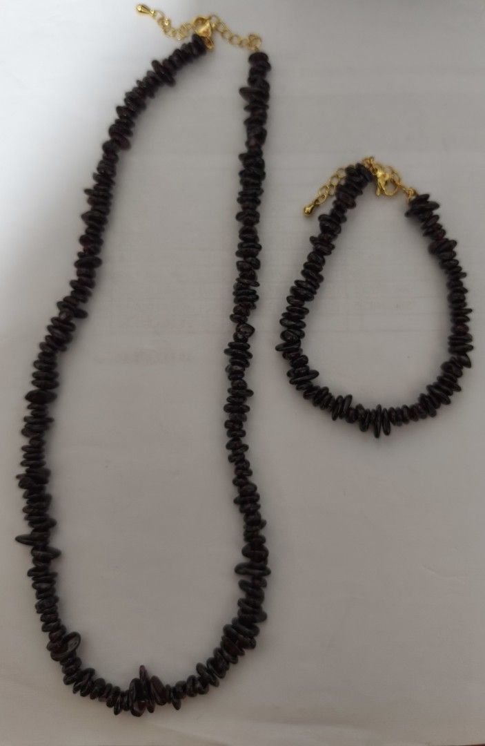 Garnet stone chip bead necklace and bracelet set (Category: Necklaces) located in Batangas. Submitted by decluttering_bliss (Listing ID 1469082306, Image 1). Description: - Matching necklace and bracelet set - Made from tumbled dark reddish-brown stone chips in a raw nugget style - Gold-tone metal clasps with extension chains for adjustable sizing - Great everyday jewelry that catches the light nicely.