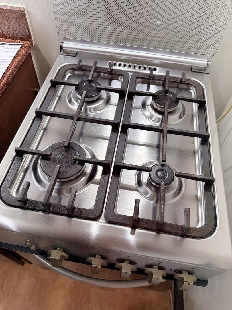 Gas Cooker with Oven and Rangehood (Category: Cookers) located in Taguig. Submitted by boxedgoodies (Listing ID 1469159093, Image 2). Description: - Brand: Whirlpool - Model: AGG540IX - Finish: Stainless steel - Features: 4 top burners and built-in oven underneath - Grates: Heavy-duty cast iron supports - Condition: Clean and well-maintained - Inclusions: Original instruction manual and paperwork - Perfect for kitchen upgrades.