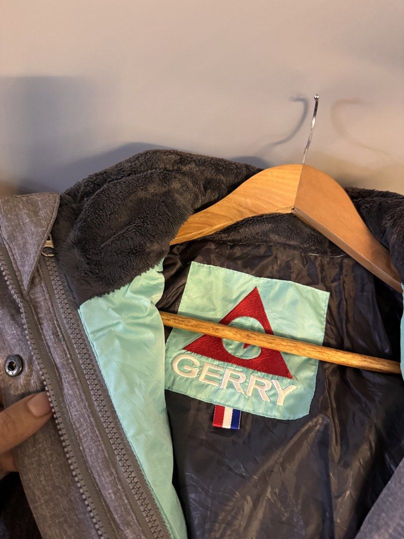 Gerry 3-in-1 Winter Jacket with Quilted Liner (Category: Coats, Jackets and Outerwear) located in Alaminos. Submitted by outfitcheck.ph (Listing ID 1469101542, Image 3). Description: - Authentic Gerry winter jacket in stylish grey and black - Includes a detachable mint green quilted inner jacket for versatile wear - Warm hood lined with dark grey fuzzy material - Secure zip-up front with snap-button storm flap - Two convenient zippered chest pock