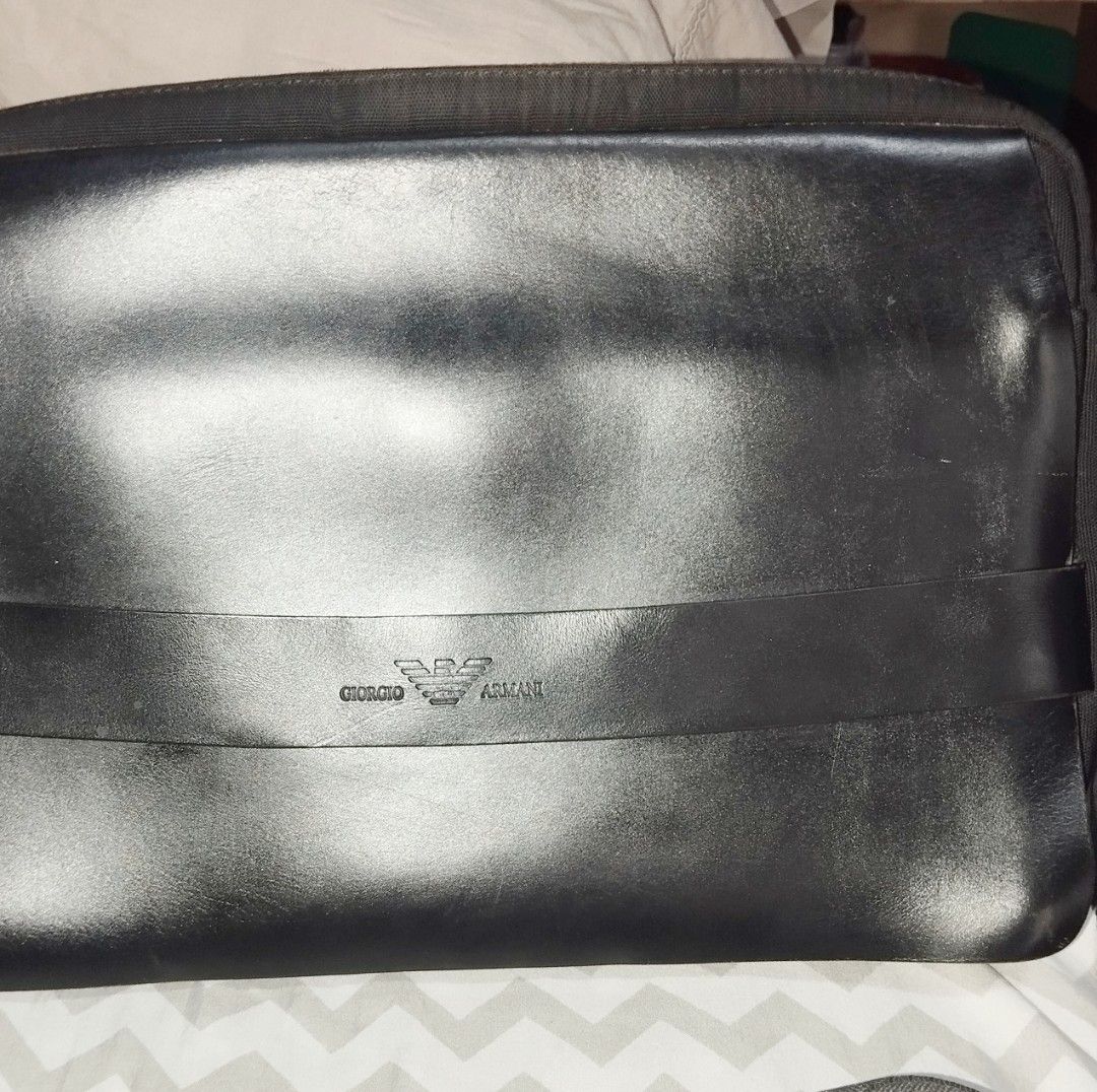 Giorgio Armani Black Leather Messenger Bag (Category: Sling Bags) located in Manila. Submitted by lene48 (Listing ID 1468932093, Image 1). Description: - Brand: Giorgio Armani - Material: Durable fabric with leather accents - Color: Classic black - Design: Embossed logo on front strap and interior lining - Strap: Adjustable shoulder strap with sturdy metal hardware - Storage: Interior zipper pocket for small essentials - Condition: Clean interior