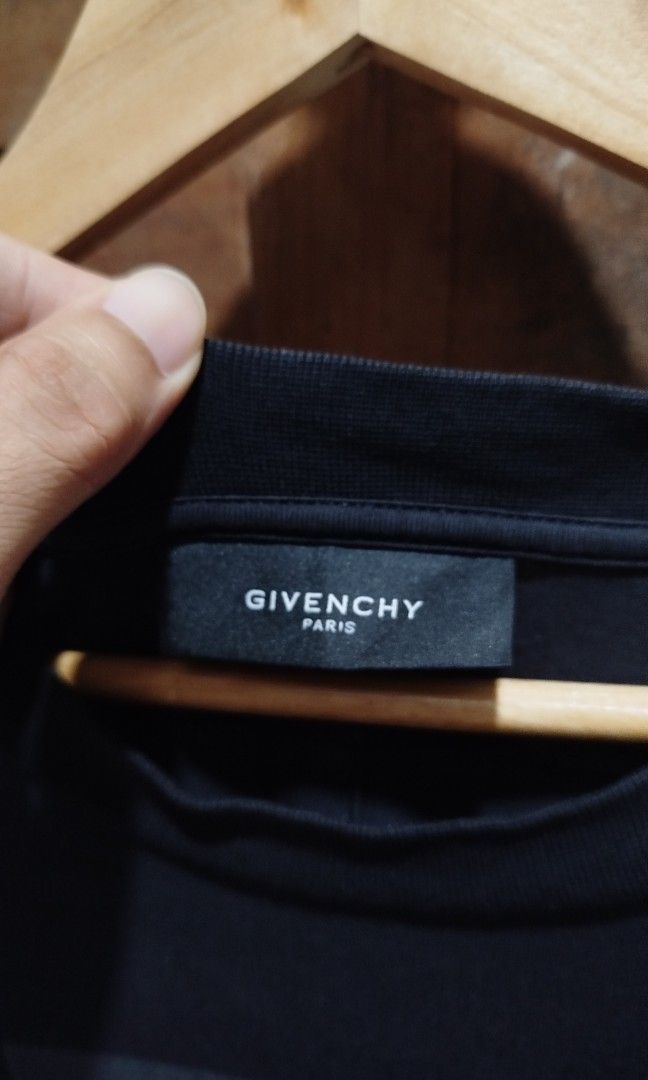 Givenchy AW13 Dobermann (Category: Announcements) located in Marikina City. Submitted by jecccc (Listing ID 1468930702, Image 3). Description: Brand: Givenchy Design/Era: Givenchy AW13 Dobermann / FW13 Riccardo Tisci Collection Key Features: Black short-sleeve tee with a front graphic combining a Doberman wearing a silver chain collar and a figure with white hair, accented by a red brush-stroke mark sign of usage.
