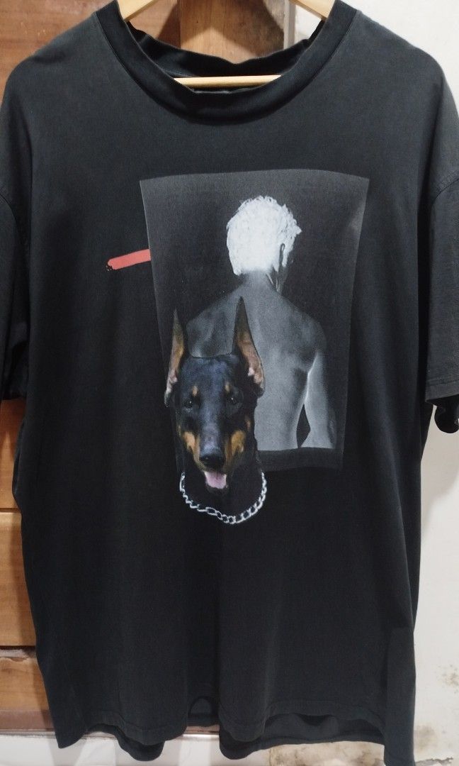 Givenchy AW13 Dobermann (Category: Announcements) located in Marikina City. Submitted by jecccc (Listing ID 1468930702, Image 1). Description: Brand: Givenchy Design/Era: Givenchy AW13 Dobermann / FW13 Riccardo Tisci Collection Key Features: Black short-sleeve tee with a front graphic combining a Doberman wearing a silver chain collar and a figure with white hair, accented by a red brush-stroke mark sign of usage.