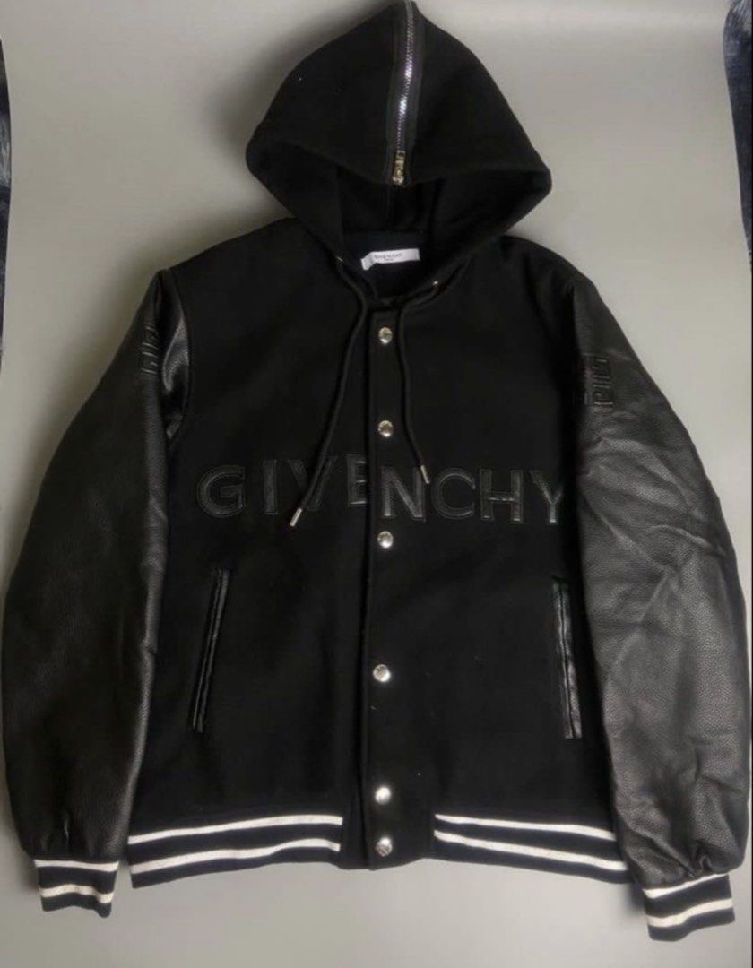 Givenchy Black Wool and Leather Bomber Hoodie Jacket (Category: Coats, Jackets and Outerwear) located in Manila. Submitted by wanwangaragesale (Listing ID 1469089082, Image 1). Description: Givenchy wool blend varsity jacket with black leather sleeves. Zip-up hood design with metallic rainbow zipper teeth. Snap button front closure, side slit pockets, striped ribbed cuffs and hem. Raised Givenchy lettering across the chest and embroidered logo pa