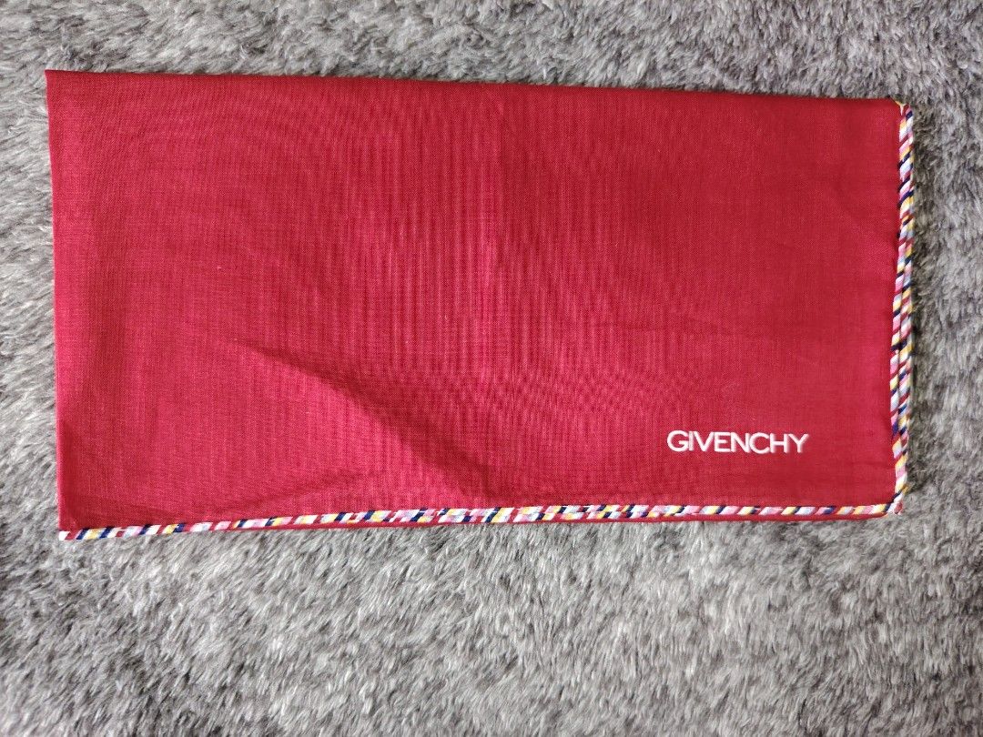 GIVENCHY PANYO (Category: Scarves) located in Valenzuela. Submitted by anna.banana10 (Listing ID 1469093075, Image 2). Description: - Brand: Givenchy - Item: Pocket square / scarf - Color: Red with multi-colored striped trim and white embroidered branding - Size: 44 x 44 cm - Material: Soft fabric texture - Condition: Excellent, clean, no stains or damage found - Neat and ready to use.