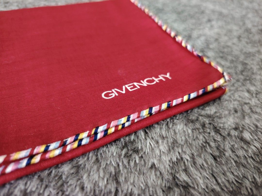 GIVENCHY PANYO (Category: Scarves) located in Valenzuela. Submitted by anna.banana10 (Listing ID 1469093075, Image 3). Description: - Brand: Givenchy - Item: Pocket square / scarf - Color: Red with multi-colored striped trim and white embroidered branding - Size: 44 x 44 cm - Material: Soft fabric texture - Condition: Excellent, clean, no stains or damage found - Neat and ready to use.