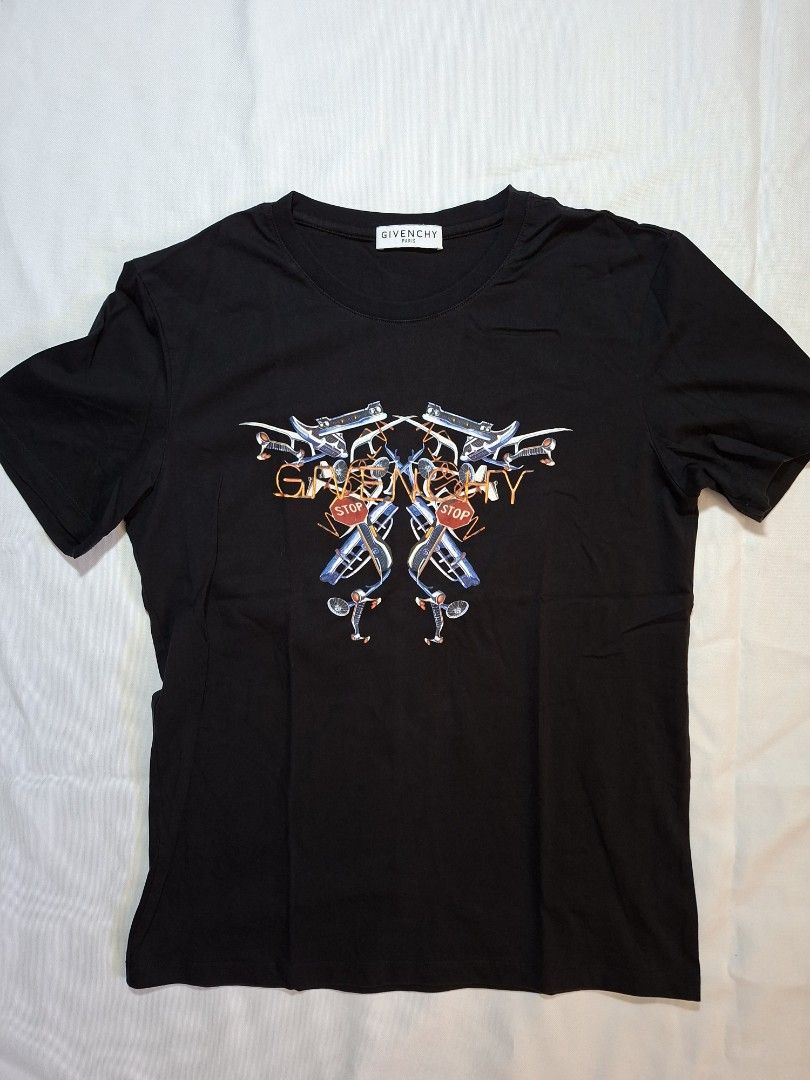Givenchy Paris Black Graphic T-Shirt Size M (Category: Activewear) located in Baguio. Submitted by restyrille77846 (Listing ID 1469071848, Image 1). Description: - Brand: Givenchy Paris - Size: 18x24 - Color: Black - Design: Graphic print on chest with bicycles, stop signs, and abstract orange line art - Details: Classic crew neckline, short sleeves, interior brand label, and care tag attached - Material: Clean and soft cotton fabric - Condition: