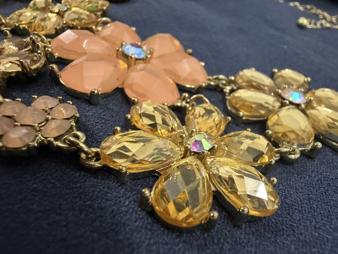 Gold Tone Floral Rhinestone Statement Necklace (Category: Necklaces) located in Makati City. Submitted by petite_preloved2 (Listing ID 1469052188, Image 3). Description: - Elegant gold-tone chain necklace with charming floral accents - Features faceted acrylic/resin petals in pale pink, champagne, and clear tones - Sparkling crystal details set in the center of every flower bloom - Adjustable length with a secure lobster clasp closure, great for 