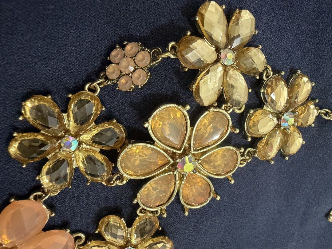 Gold Tone Floral Rhinestone Statement Necklace (Category: Necklaces) located in Makati City. Submitted by petite_preloved2 (Listing ID 1469052188, Image 2). Description: - Elegant gold-tone chain necklace with charming floral accents - Features faceted acrylic/resin petals in pale pink, champagne, and clear tones - Sparkling crystal details set in the center of every flower bloom - Adjustable length with a secure lobster clasp closure, great for 