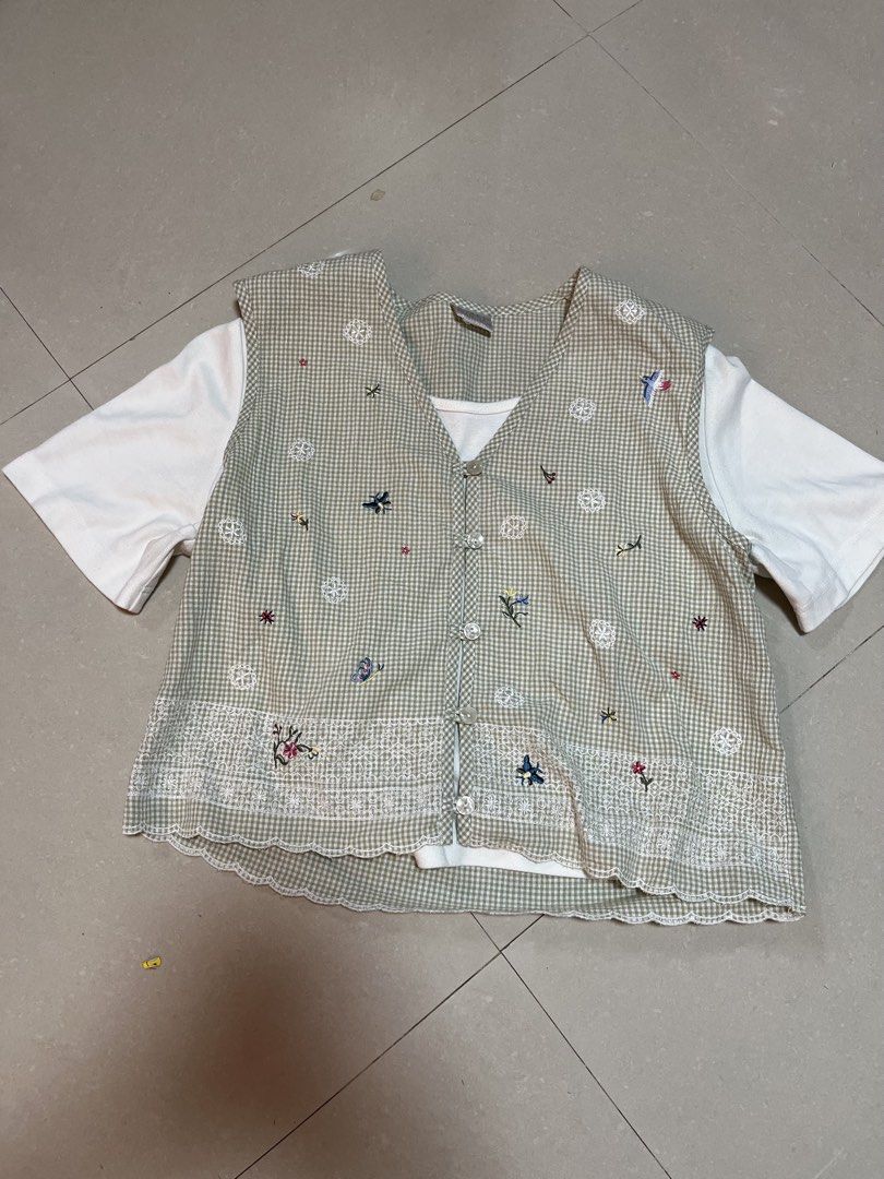 Green Gingham Embroidered Vest With White Tee Set (Category: Sleeveless) located in Guiguinto. Submitted by junibunn (Listing ID 1469029649, Image 1). Description: - Style: Green & white gingham vest layered over a basic white short-sleeve tee - Details: Button-up front with delicate floral embroidery and charming blue insect accents - Hem: Scalloped lace hem along the bottom edge - Condition: Pre-loved piece with lots of character - Perfect for: