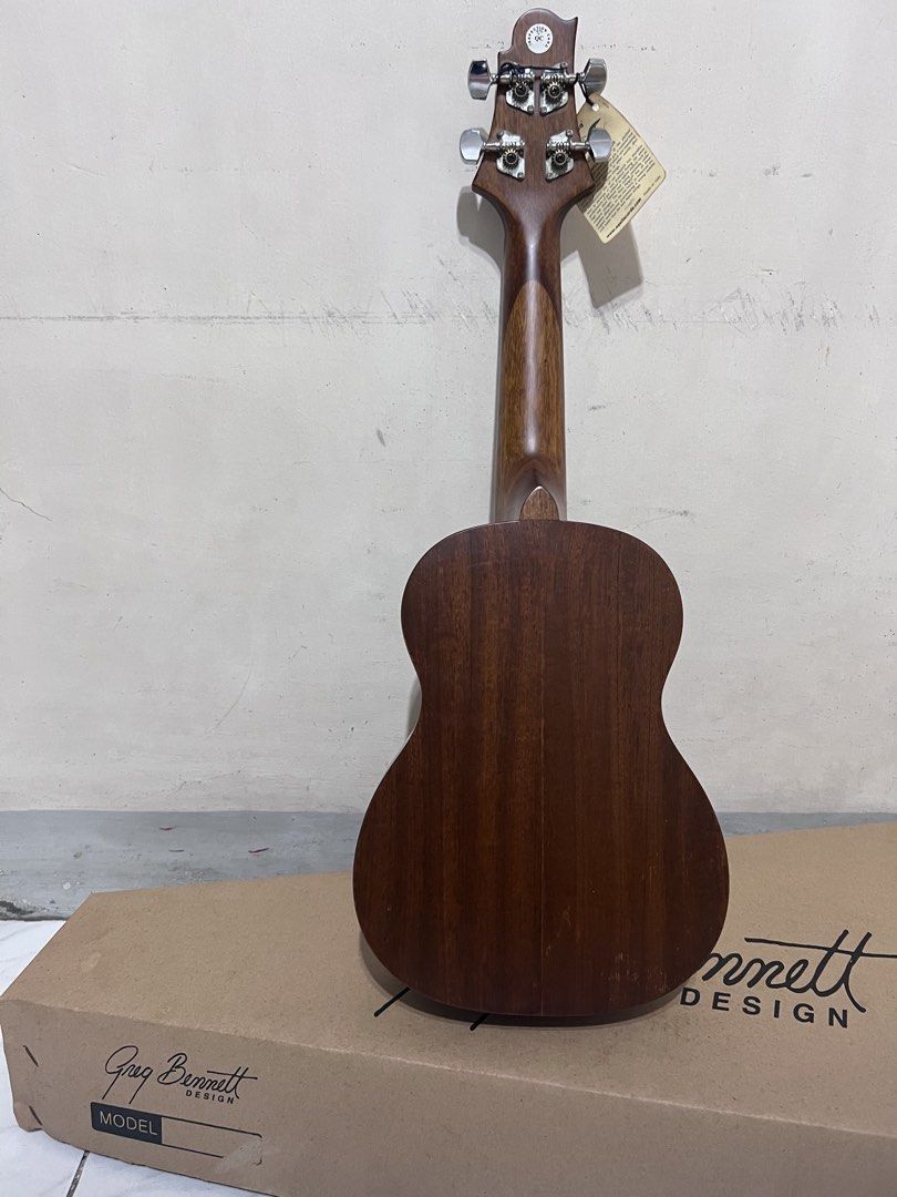 Greg Bennett Design Samick Ukulele (Category: Musical Instruments) located in Quezon City. Submitted by john7434350672 (Listing ID 1469160813, Image 3). Description: - Model: Greg Bennett Design Samick UK-507NS concert ukulele - Condition: Brand new with factory tags and QC sticker still attached - Appearance: Rich brown wood finish with a clean fretboard - Hardware: Equipped with smooth nylon strings - Inclusions: Comes complete with the origina