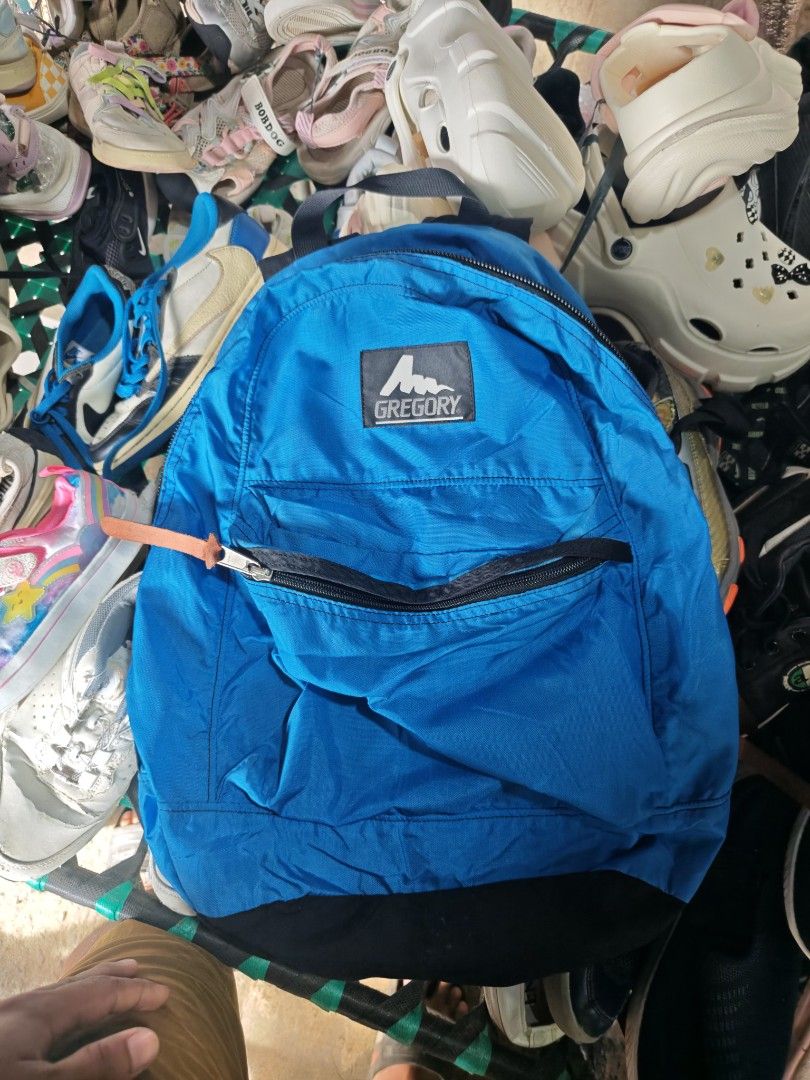 Gregory Blue Backpack with Black Bottom (Category: Backpacks) located in Isulan. Submitted by jaysthrift (Listing ID 1469068004, Image 1). Description: - Brand: Gregory - Color: Bright blue with black base - Material: Durable nylon fabric - Storage: Roomy main compartment and a slanted front zippered pocket - Details: Contrast orange pull tab and stitched rectangular logo patch - Style: Simple, functional everyday daypack.