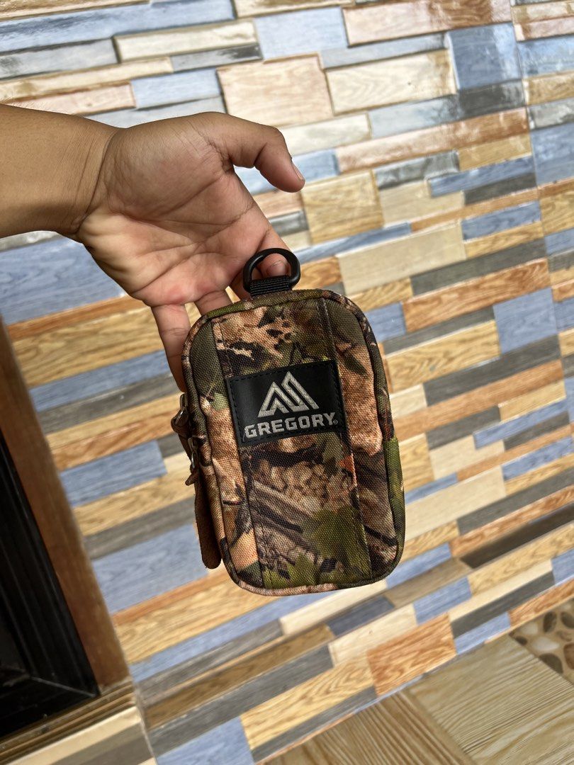 Gregory Cottonwood Camo Quick Pocket Utility Pouch (Category: Belt bags, Clutches and Pouches) located in Iba. Submitted by saploot (Listing ID 1469115054, Image 3). Description: - Brand: Gregory - Model: Quick Pocket Pouch - Color/Pattern: Cottonwood Camo - Material: Rugged canvas with genuine leather zipper pulls - Features: Black back panel with two gear-mounting strap attachments and a top hanging loop - Ideal Use: Compact everyday carry for 