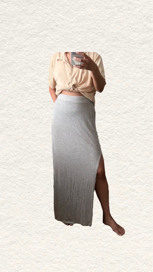 Grey Long Cotton Skirt with Side Slit (Category: Skirts) located in Quezon City. Submitted by zealhorse_a9f3c3 (Listing ID 1467344278, Image 2). Description: - Color: Grey - Style: Long maxi skirt with a straight cut design - Material: Soft and comfortable jersey - Waistband: Stretchable elastic for a great fit - Feature: High slit on one side for easy walking - Versatility: Perfect basic piece to match with t-shirts and crop tops for casual ever