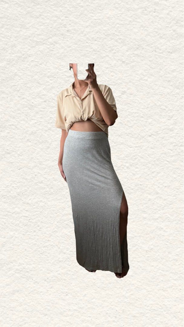 Grey Long Cotton Skirt with Side Slit (Category: Skirts) located in Quezon City. Submitted by zealhorse_a9f3c3 (Listing ID 1467344278, Image 3). Description: - Color: Grey - Style: Long maxi skirt with a straight cut design - Material: Soft and comfortable jersey - Waistband: Stretchable elastic for a great fit - Feature: High slit on one side for easy walking - Versatility: Perfect basic piece to match with t-shirts and crop tops for casual ever