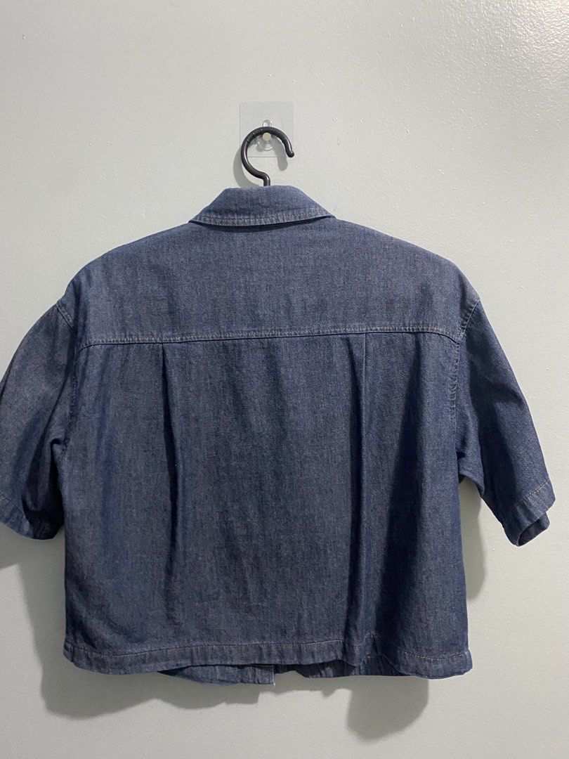 GU Blue Denim Short Sleeve Button Up Shirt (Category: Shirts) located in Mandaluyong City. Submitted by _adjh (Listing ID 1469143576, Image 3). Description: - Brand: GU - Item: Denim short-sleeve shirt - Color: Blue - Material: 100% cotton - Fit: Boxy cropped fit - Details: Button-front closure, classic collar, two chest pockets with button flaps, and upper back pleats.