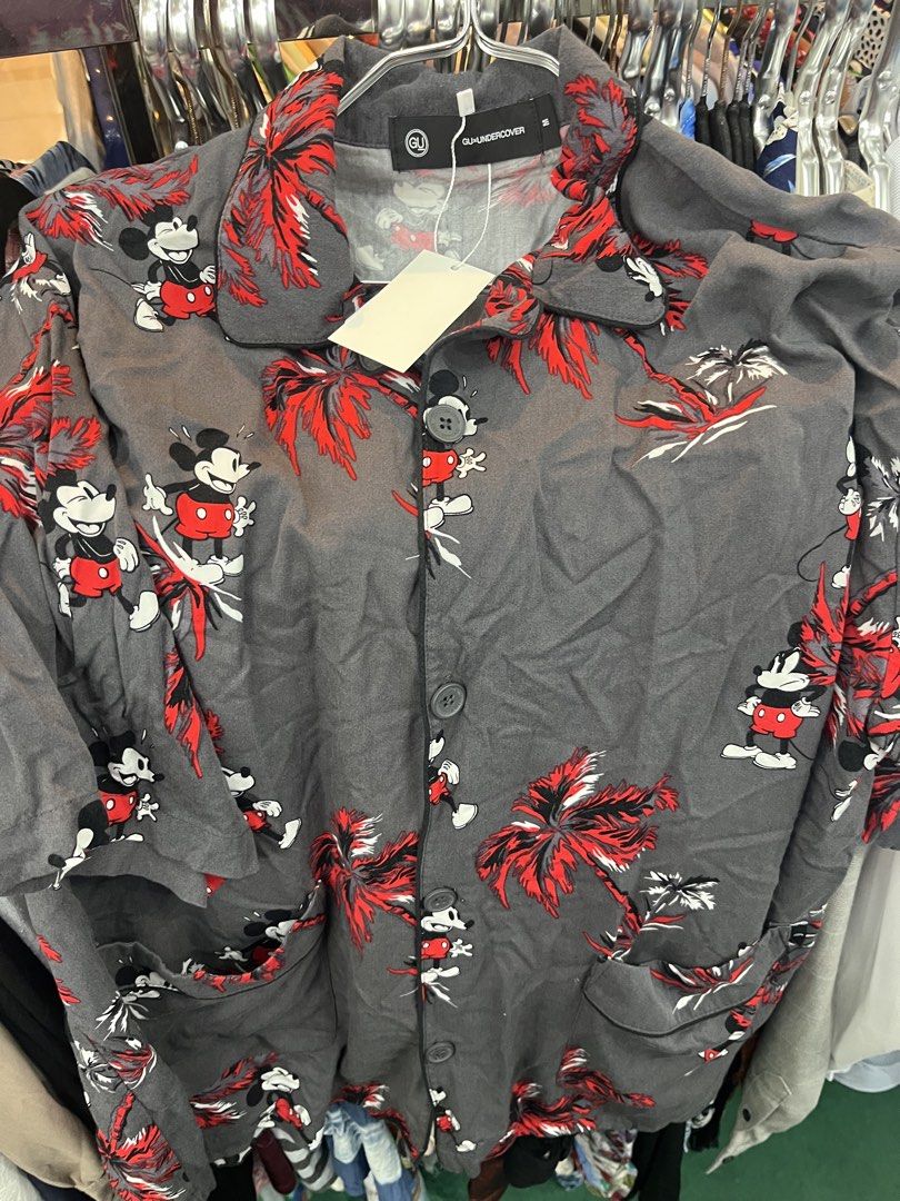 GU x UNDERCOVER Mickey Mouse Tropical Shirt (Category: Shirts) located in Manila. Submitted by shanaaa.collects (Listing ID 1469010793, Image 1). Description: - Brand: GU x UNDERCOVER collaboration - Design: Grey fabric with Mickey Mouse prints and red palm trees - Details: Short sleeves, lapel collar, branded buttons - Size: M - Material: Rayon - Condition: Brand new with tags (BNWT).